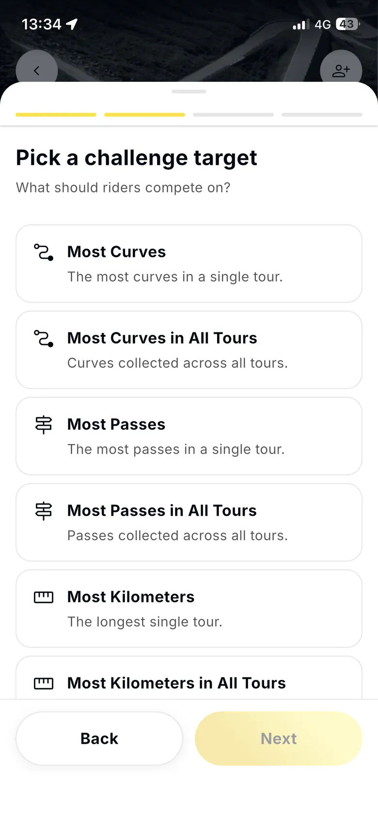 New Create challenge wizard, step two of four: Pick a challenge target, with a list of targets such as Most Curves, Most Passes and Most Kilometers, each in a single tour or across all tours, and Back and Next buttons.