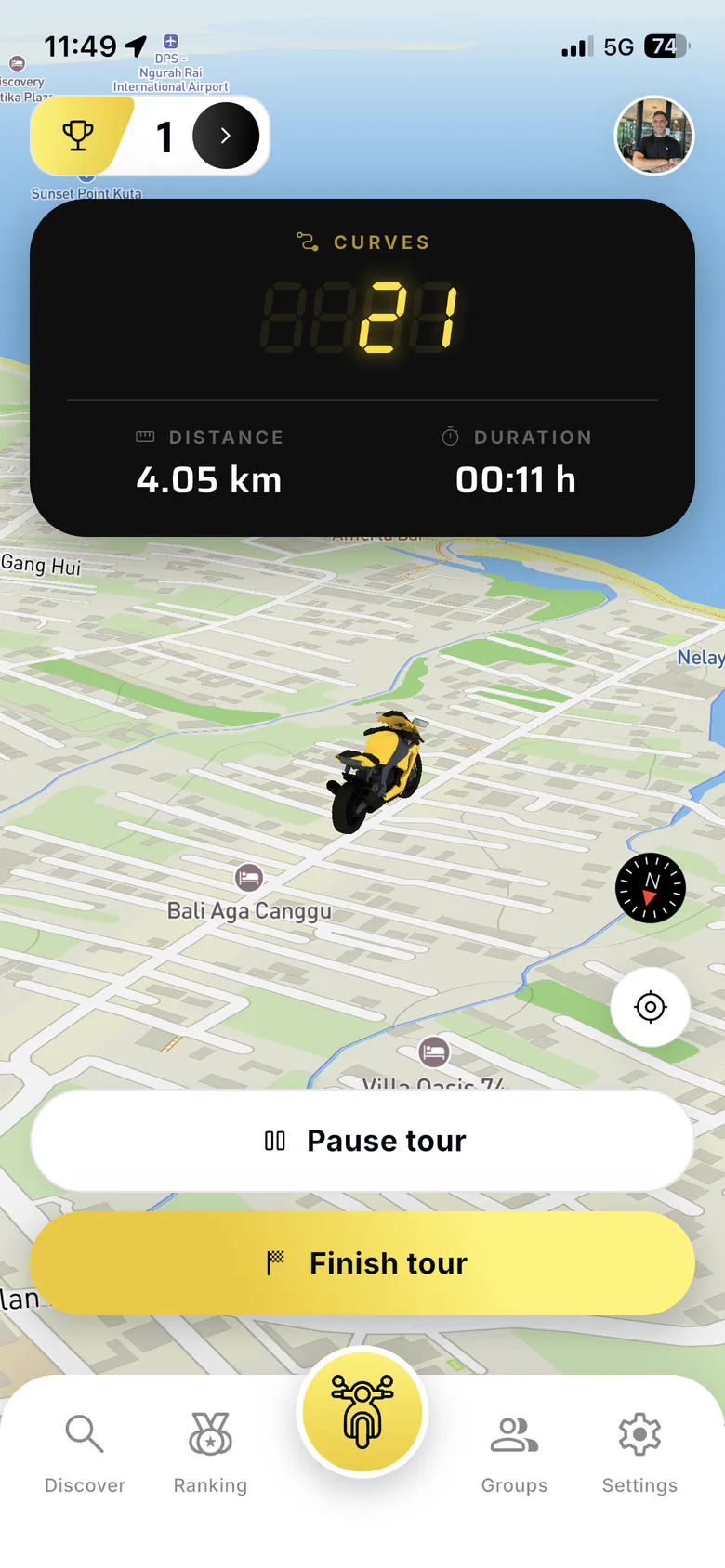 New Ride tab: a dark panel with a seven-segment curve counter at 21, 4.05 km distance and 00:11 h duration over a tilted map with a yellow motorcycle marker, and Pause tour and Finish tour buttons above the tab bar.